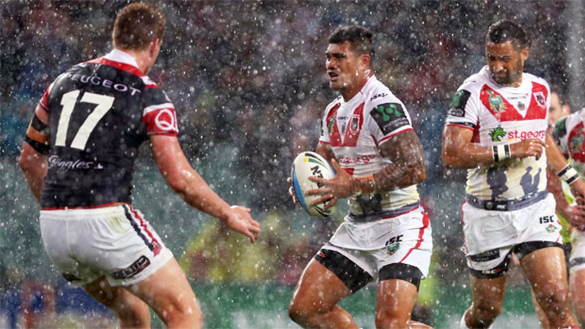 Peter Mata'utia makes a carry as the rain crashes the party during the Dragons' clash with the Roosters.