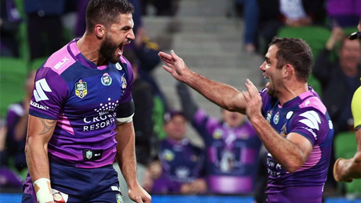 Jesse Bromwich and Cameron Smith celebrate Bromwich's opening try against the Rabbitohs.