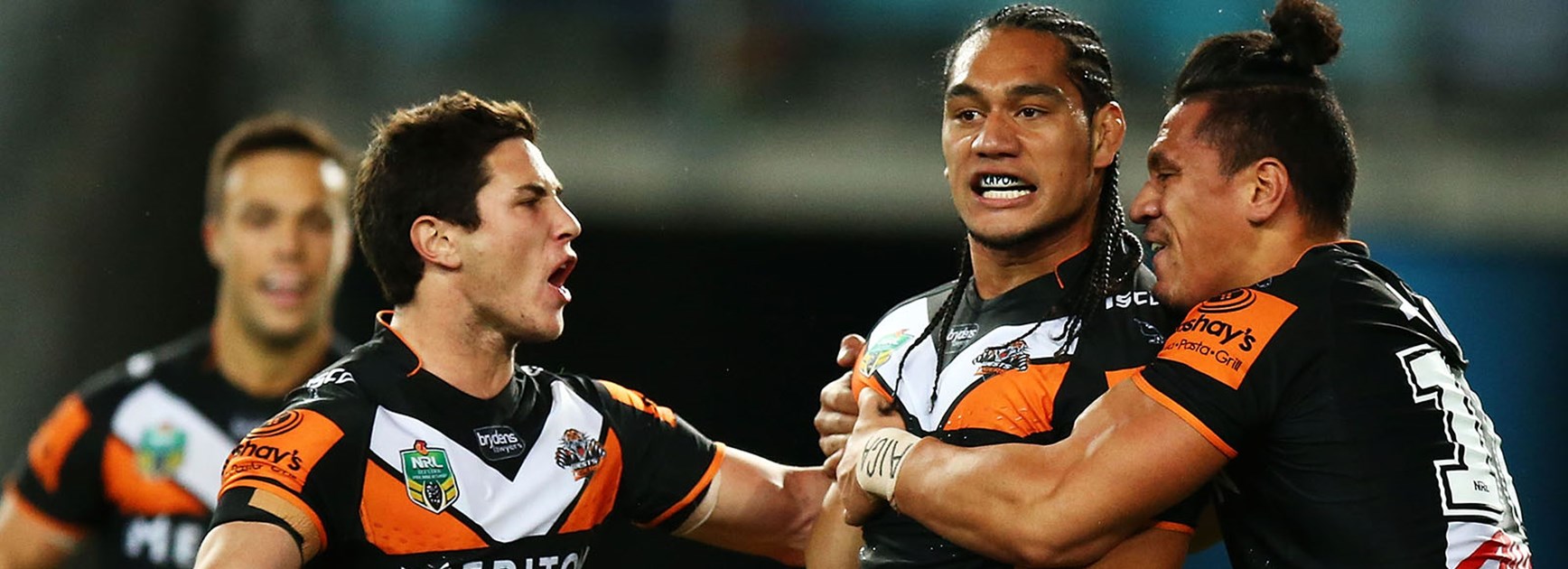 Wests Tigers celebrate Martin Taupau's second try against South Sydney at ANZ Stadium.