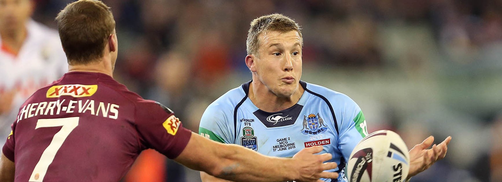 Trent Hodkinson gets a pass away in front of opposite number Daly Cherry-Evans during Origin II at the MCG.
