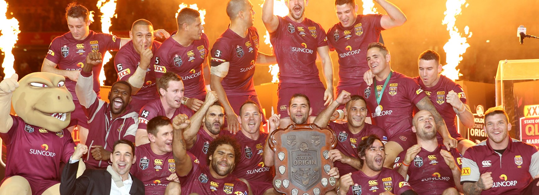 Queensland players celebrate on stage following their record-breaking win in Origin III.