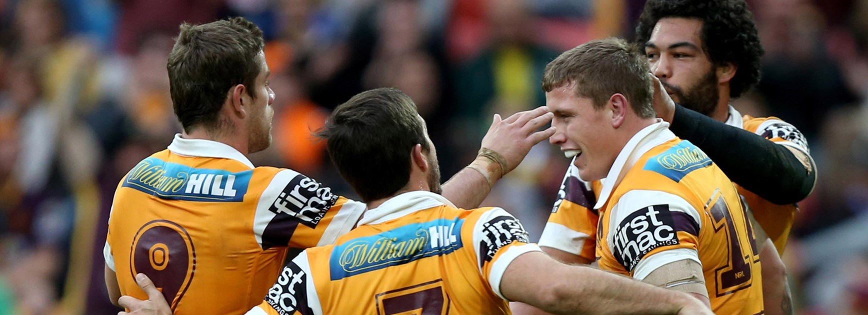 Broncos players celebrate Jarrod Wallace's try against the Tigers in Round 19.