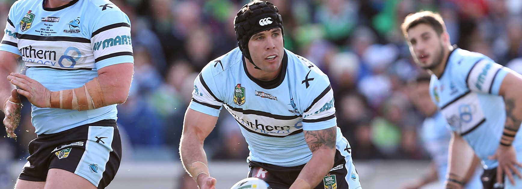 Sharks hooker Michael Ennis passes in his side's clash with the Raiders.