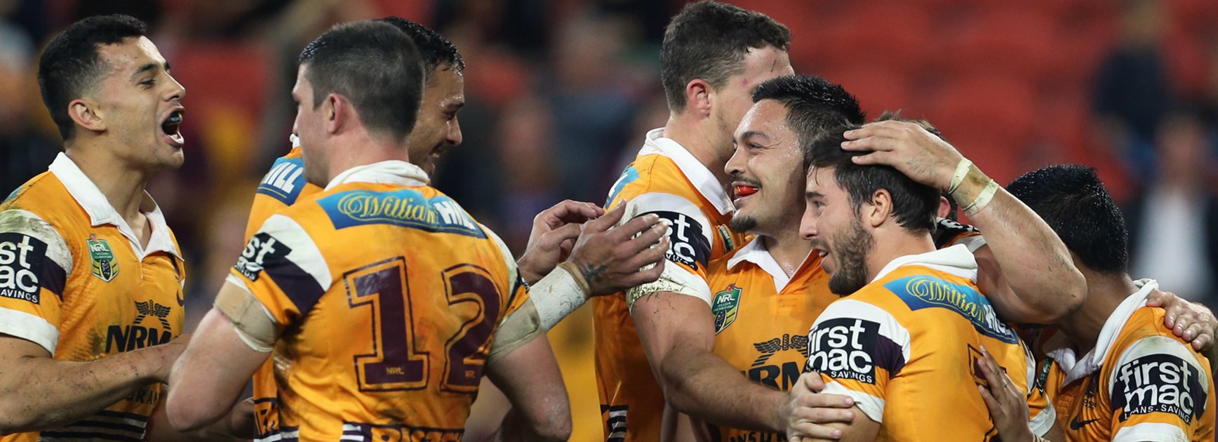 Broncos players celebrate during their Round 20 win over the Titans.