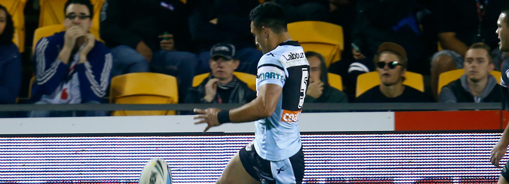 Valentine Holmes puts in a kick for himself to score.