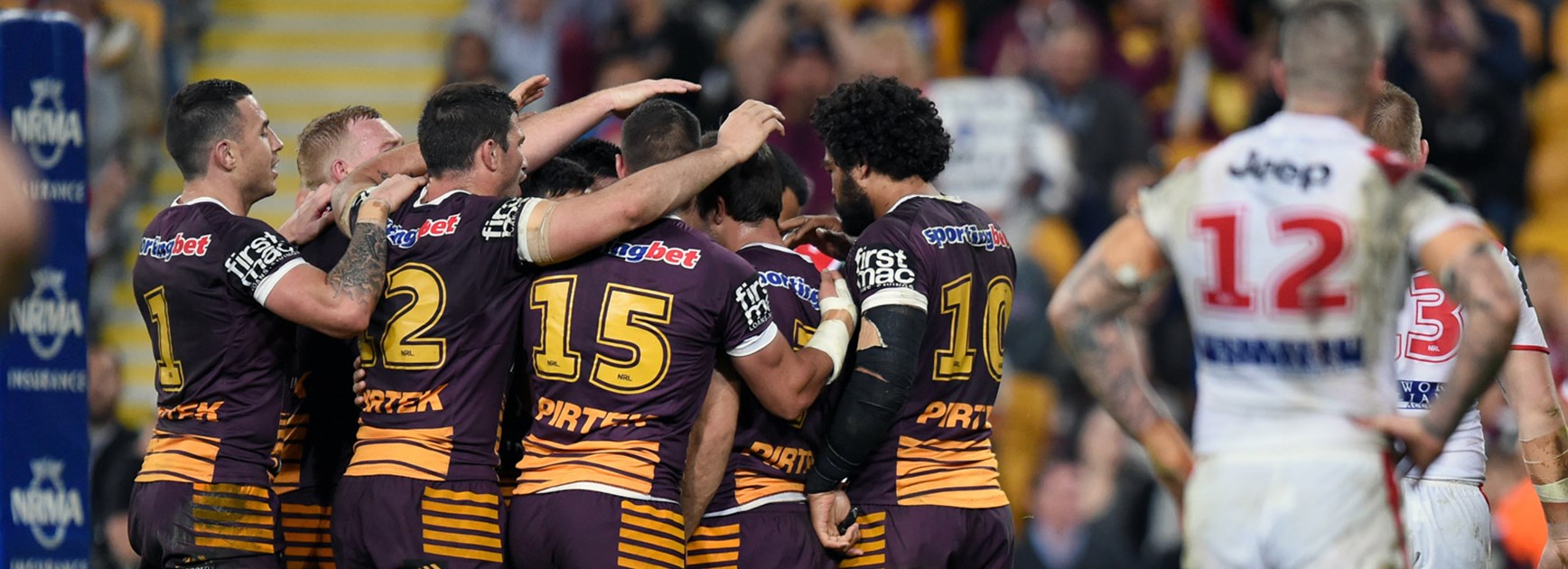Broncos players celebrate during their Round 23 win over the Dragons.