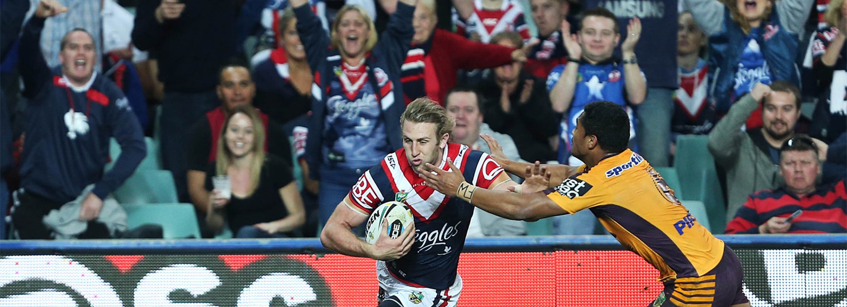 Brenden Elliot runs clear for the Roosters against the Broncos on Saturday night.