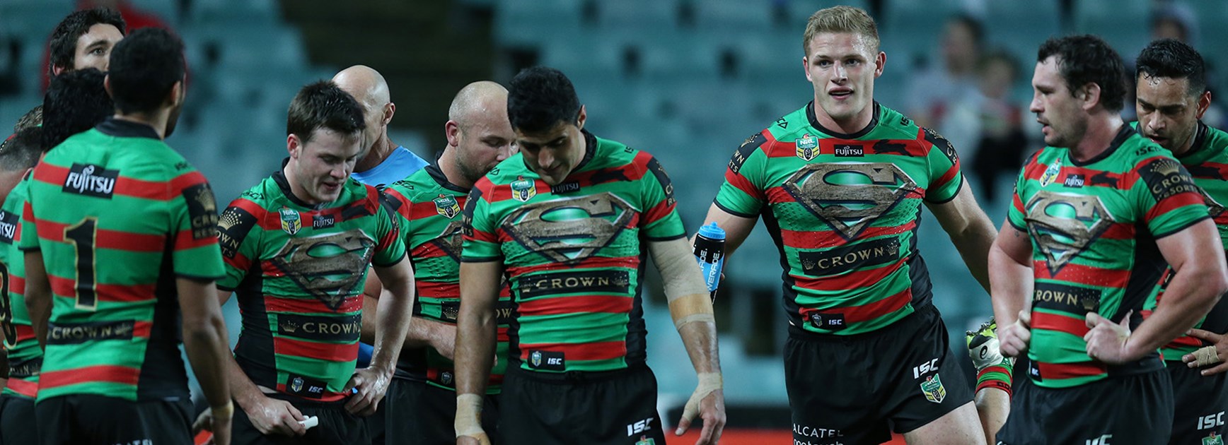 South Sydney players look on dejected after another Broncos try.