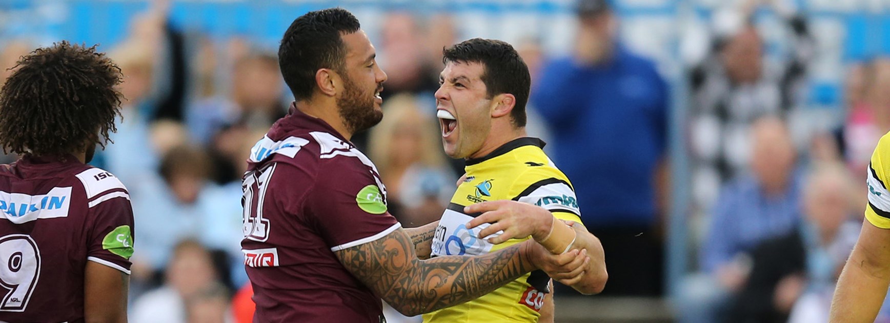 Feleti Mateo and Michael Ennis get up close and personal during Manly's clash with Cronulla.