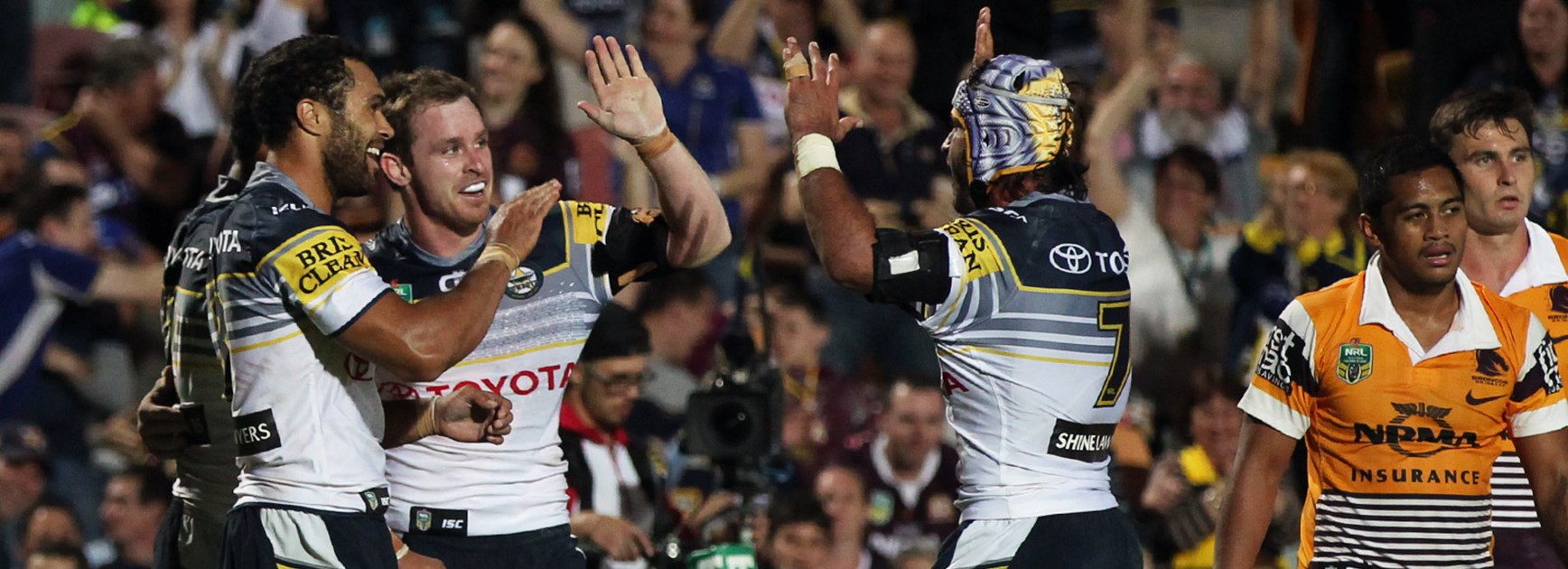 Michael Morgan celebrates his hat-trick against the Broncos in Round 10 with Cowboys teammates Justin O’Neill and Johnathan Thurston.