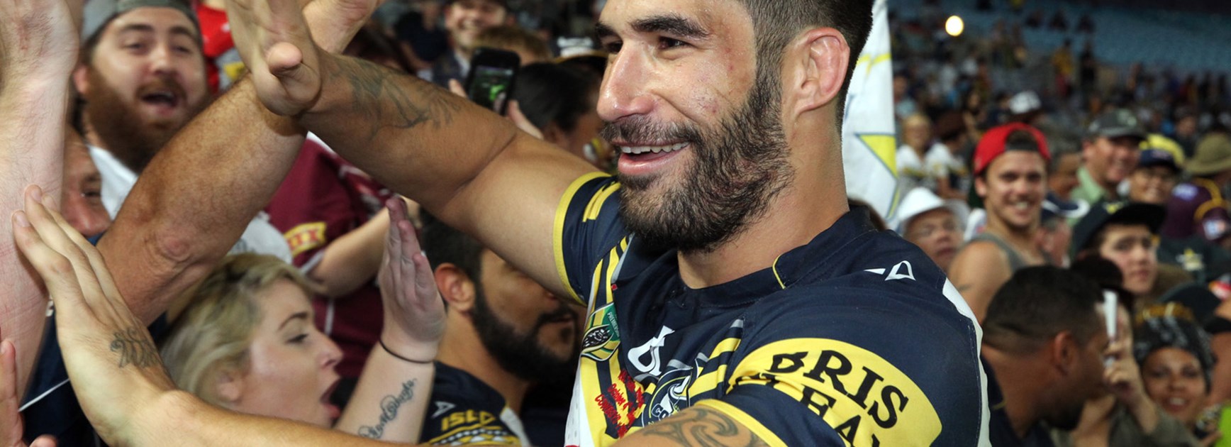 Cowboys prop James Tamou celebrates with fans following his side's golden point grand final win.