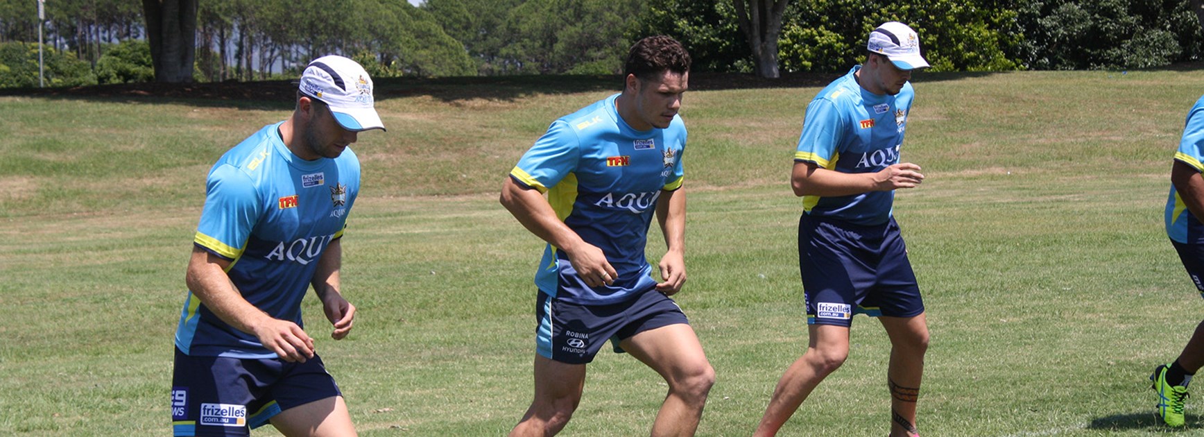 Kane Elgey (left), James Roberts and Nathan Davis are put through their paces on day one of Titans pre-season training.