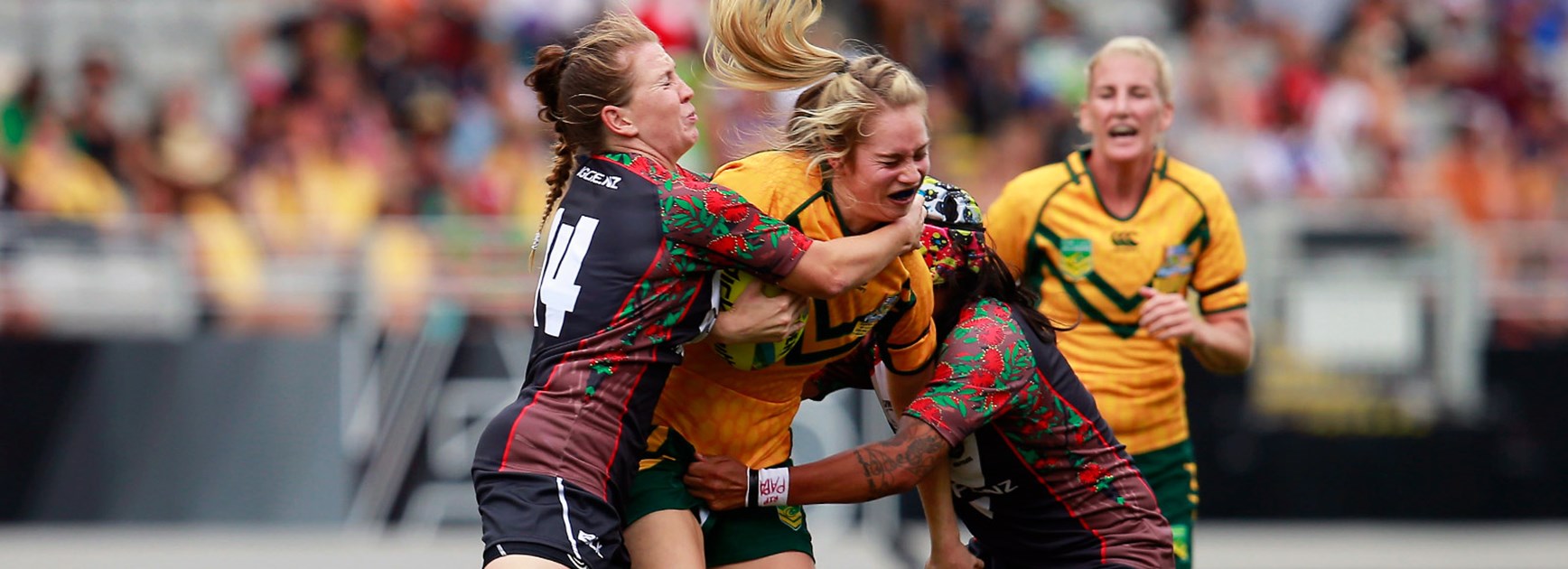 Jillaroos back-rower Kezie Apps is crunched by the Kiwi Ferns defence in the 2015 Auckland Nines.