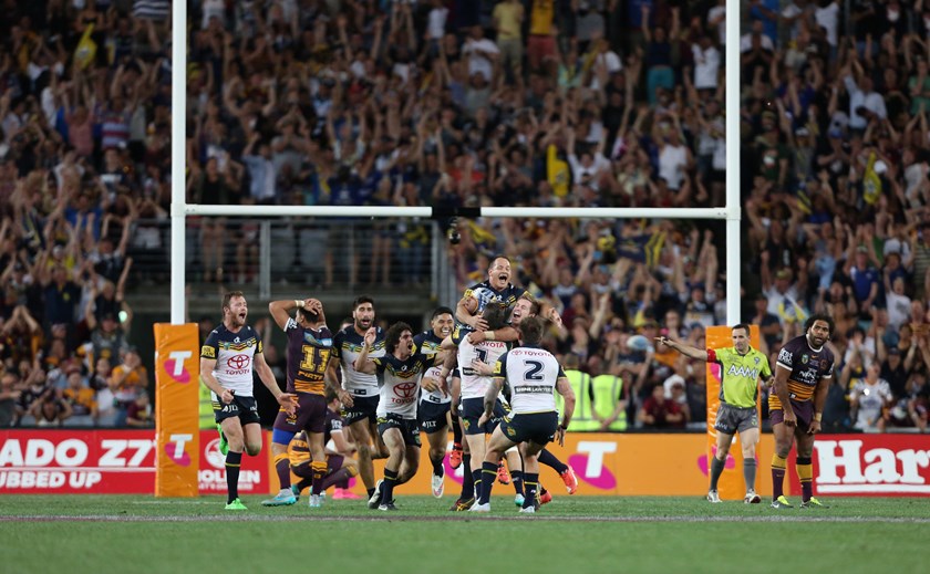 Cowboys players swamp Johnathan Thurston after the victory.