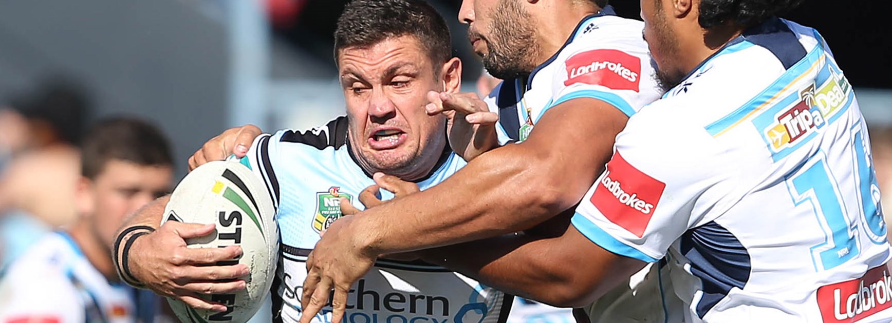Sharks forward Chris Heighington contained by Titans defenders in Round 6.