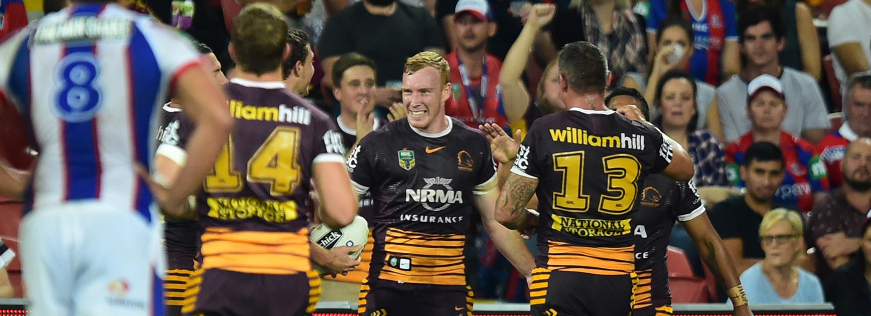 The Broncos celebrate a try against the Knights at Suncorp Stadium.