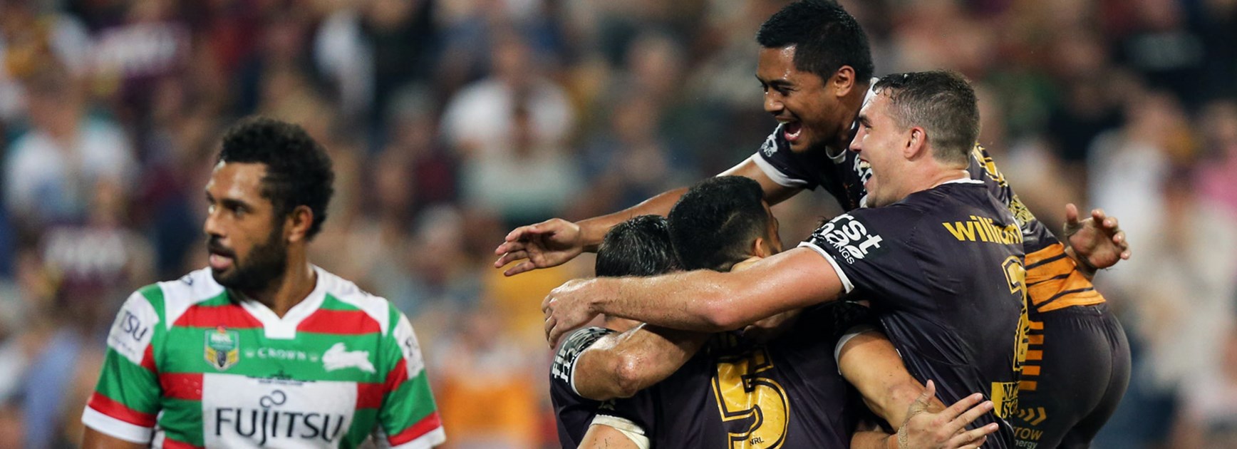 Broncos players celebrate their Round 8 win over the Rabbitohs.