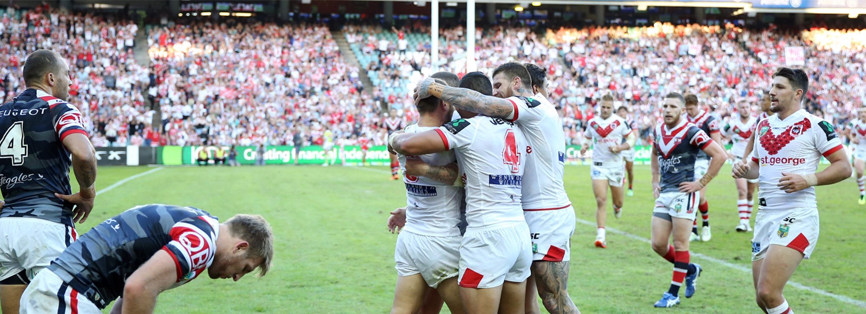 The Dragons celebrate a try against the Roosters on Anzac Day.