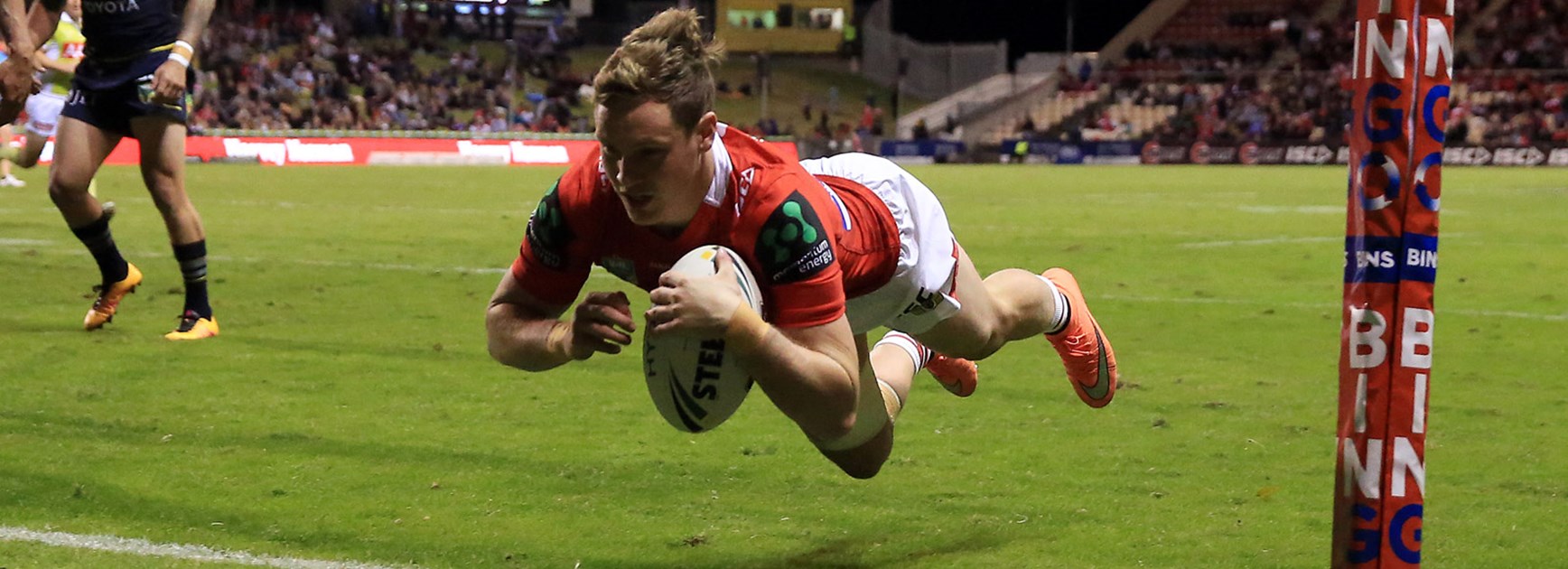 Dragons winger Kurt Mann dives over for a try against the Cowboys.