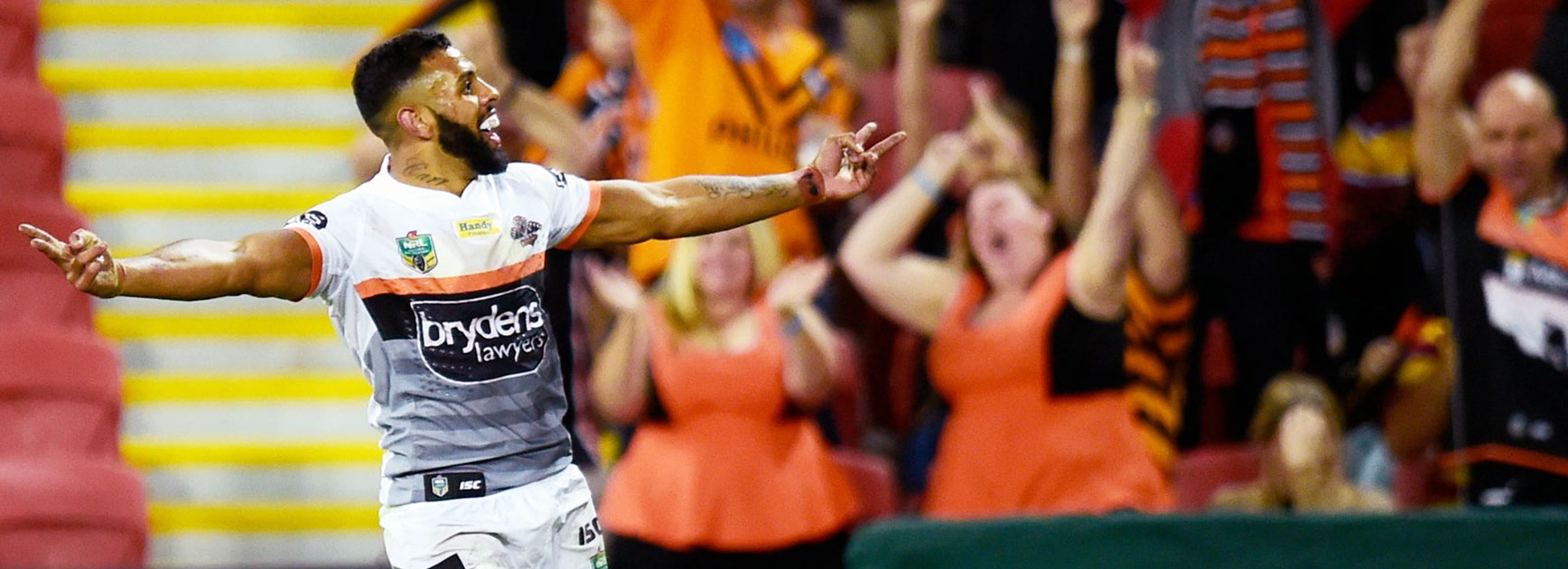 Josh Addo-Carr celebrates a try in front of Wests Tigers fans.