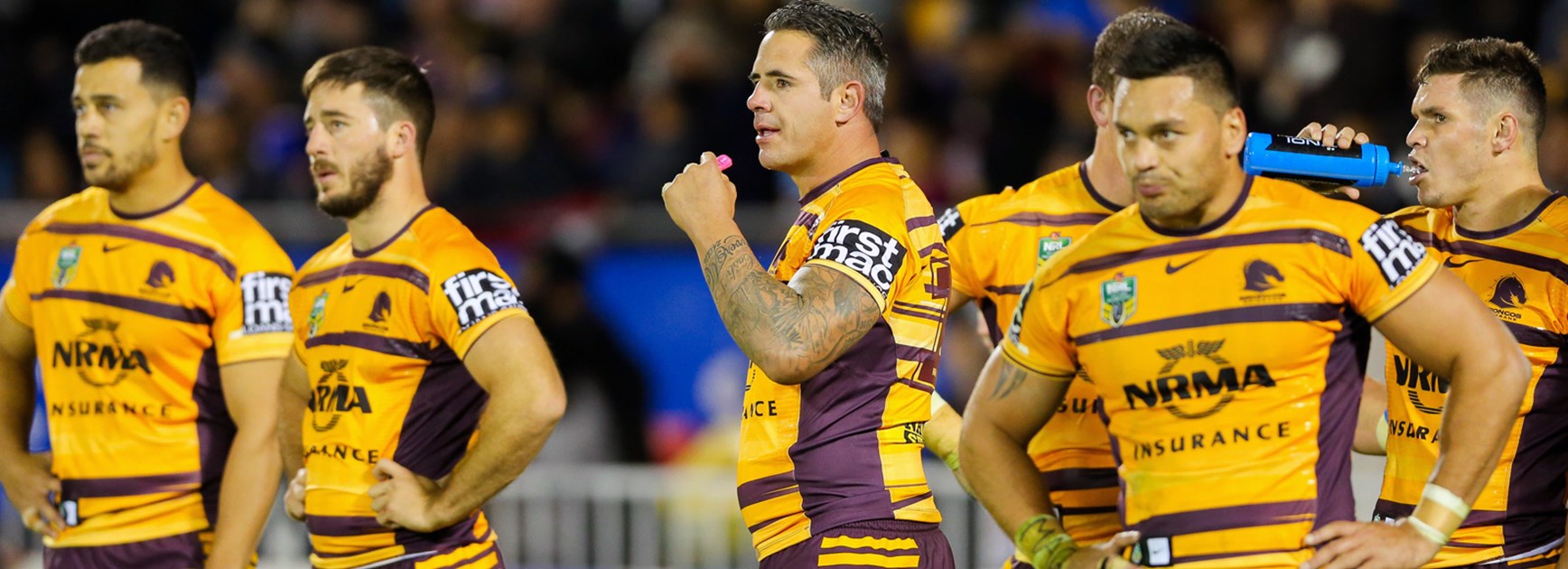 Broncos players look on dejected during their loss to the Warriors.