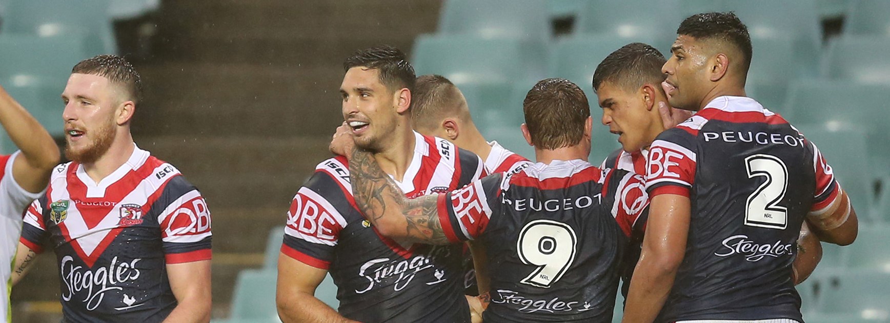 The Roosters celebrate a try against the Wests Tigers.