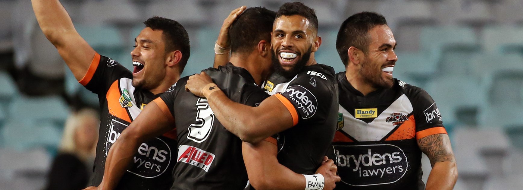 Wests Tigers players celebrate during their Round 14 win over the Rabbitohs.