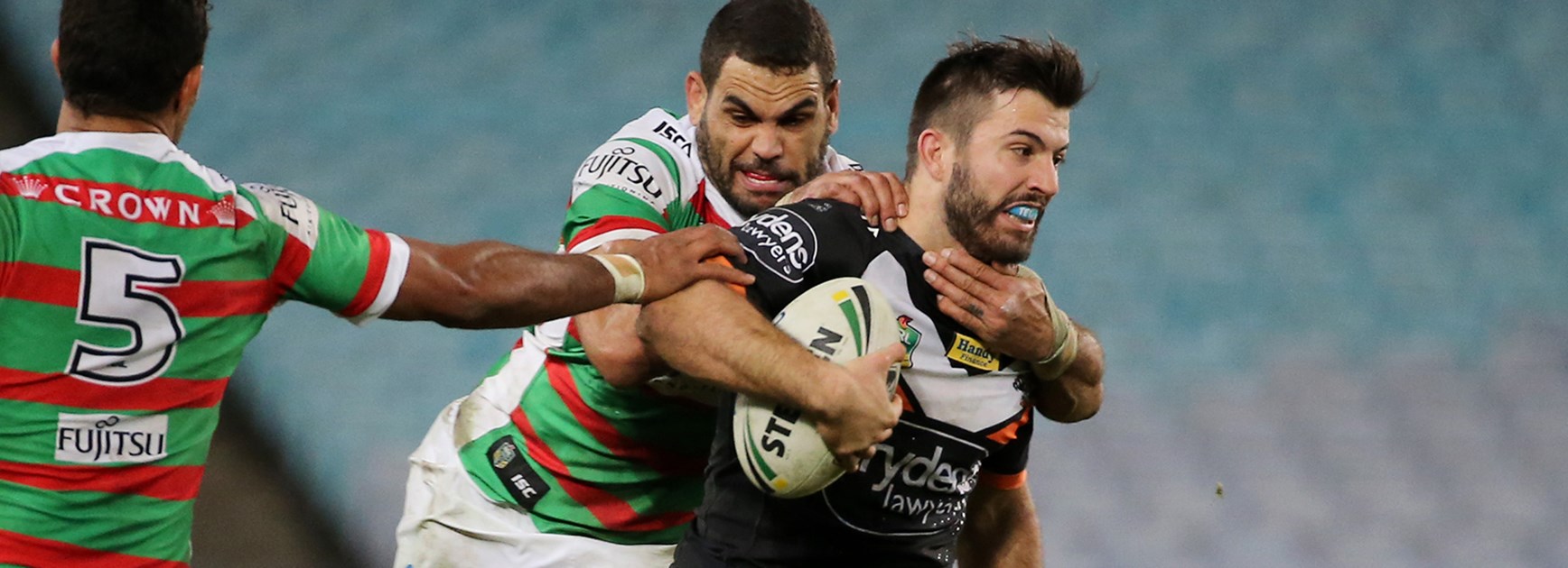 Wests Tigers fullback James Tedesco is rounded up by Souths five-eighth Greg Inglis in Round 14.