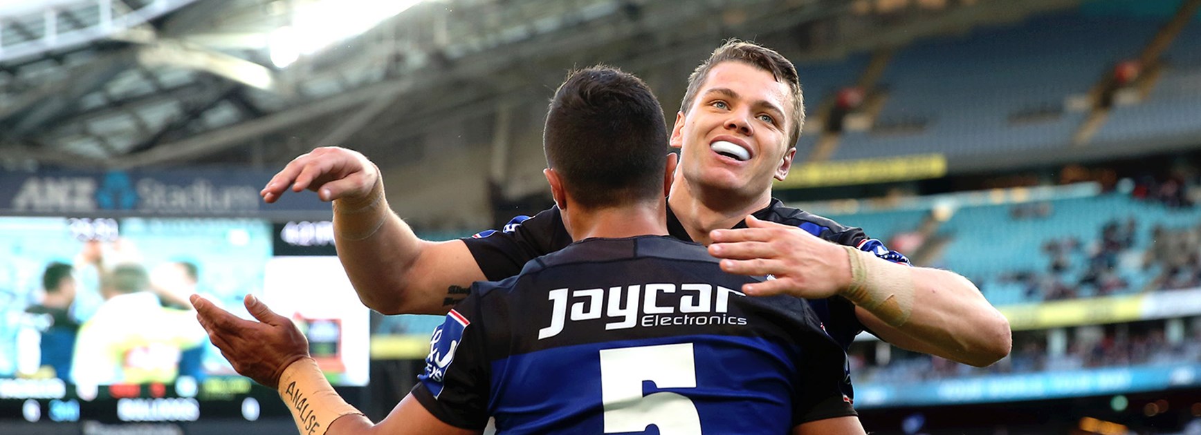 The Bulldogs celebrate Sam Perrett's try against the Dragons at ANZ Stadium.