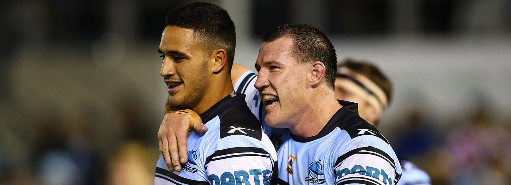The Sharks celebrate a spectacular length of the field try to Valentine Holmes.