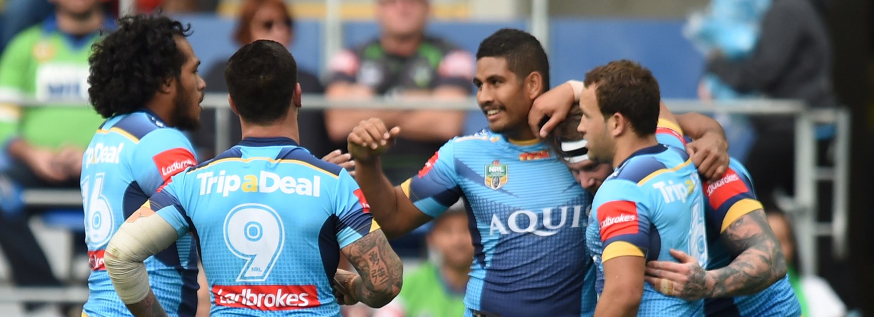 The Titans celebrate a try against the Raiders.