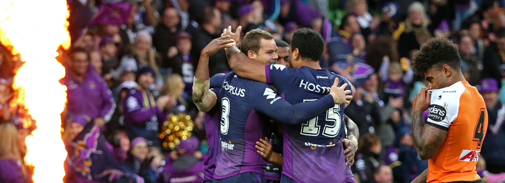 Melbourne players celebrate another try against the Wests Tigers at AAMI Park.