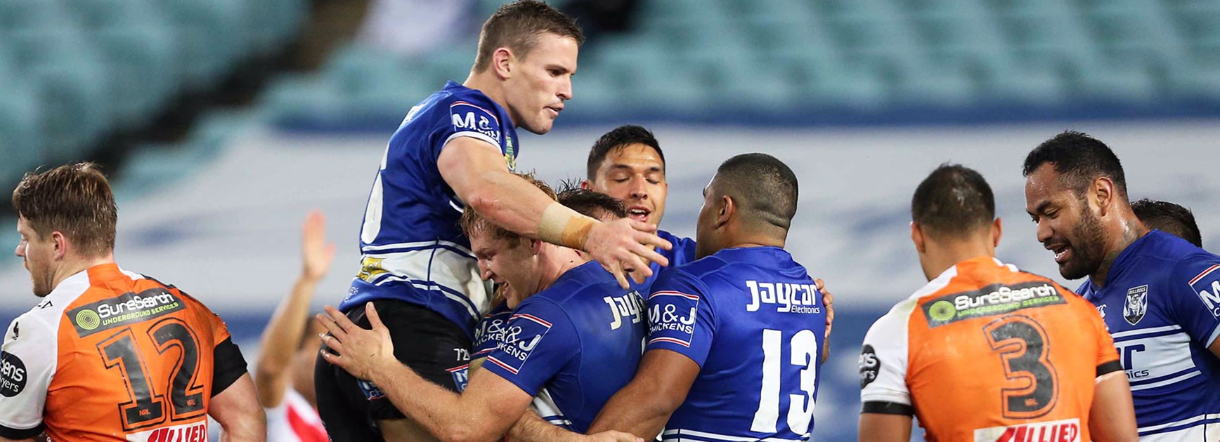 Bulldogs players celebrate during their victory over Wests Tigers.