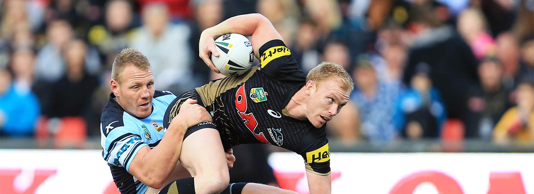 Cronulla's Luke Lewis tackles Penrith's Peter Wallace on Sunday afternoon.