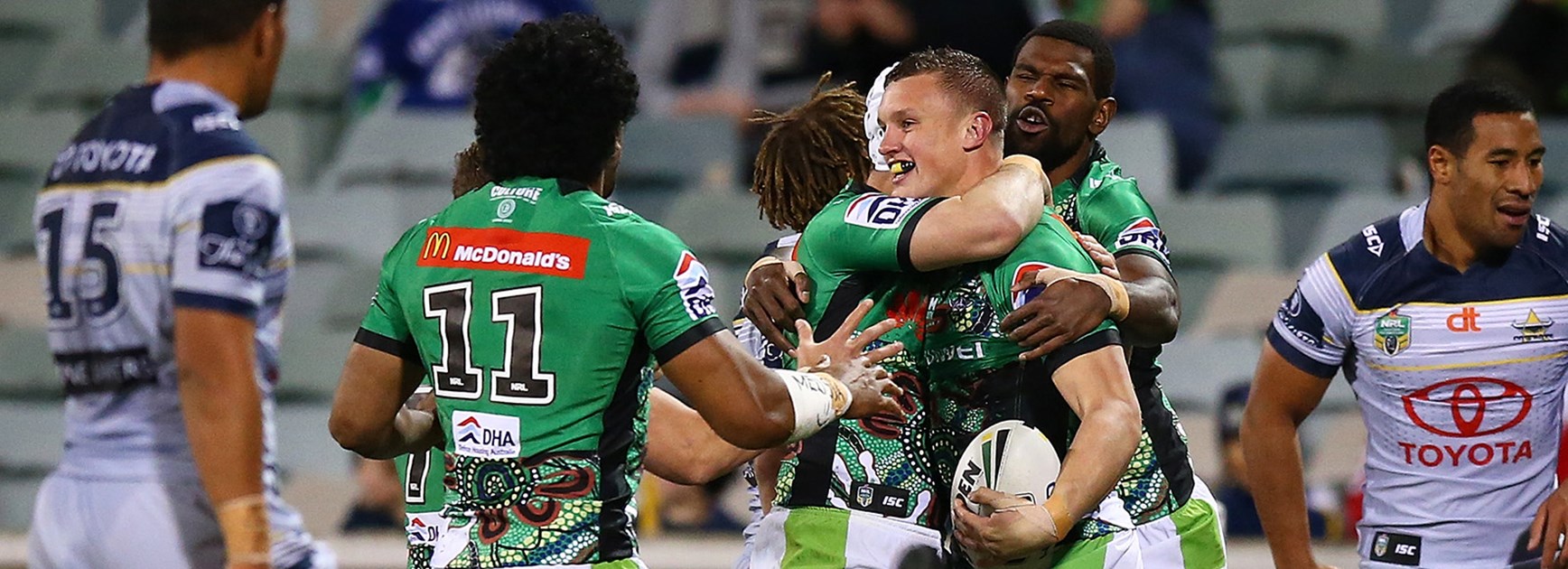 Canberra celebrate after scoring another try against the Cowboys in Round 18.