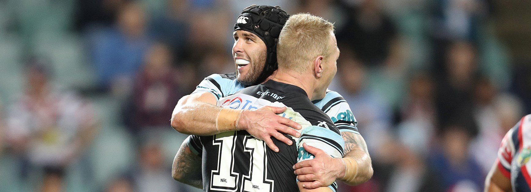 Mick Ennis and Luke Lewis celebrate a try against the Roosters in Round 19.