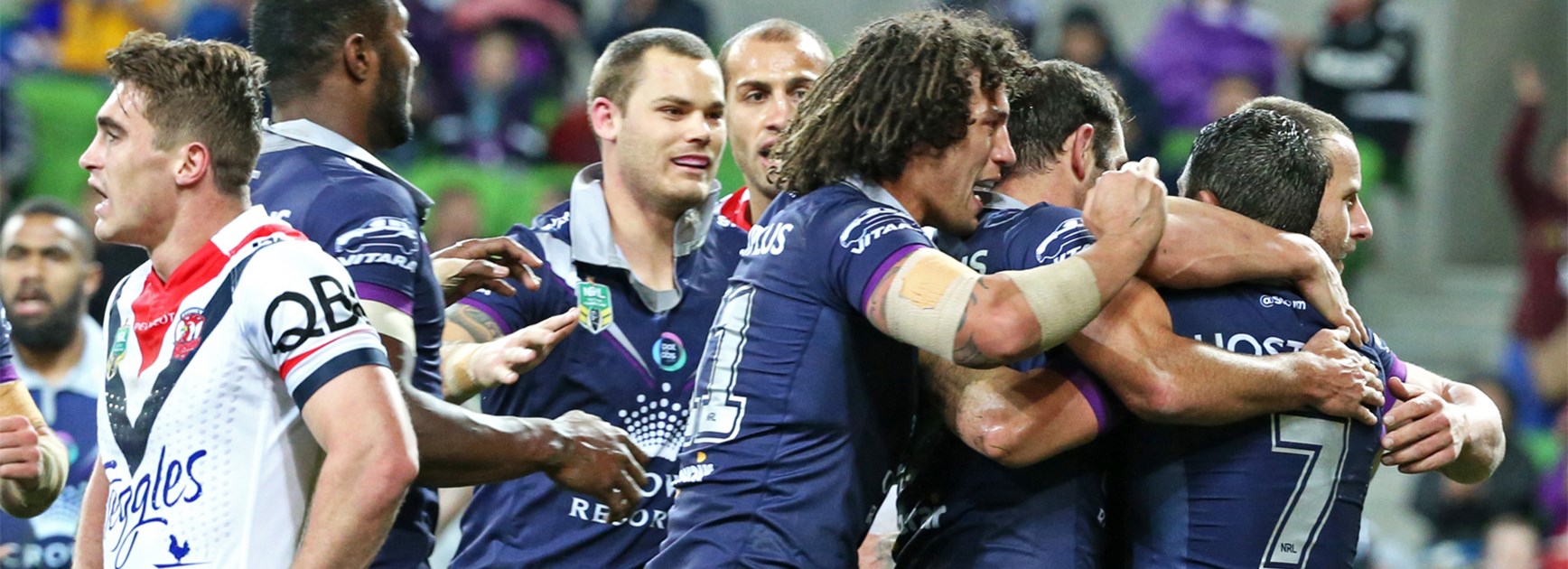 The Melbourne Storm celebrate a try against the Roosters on Saturday night.
