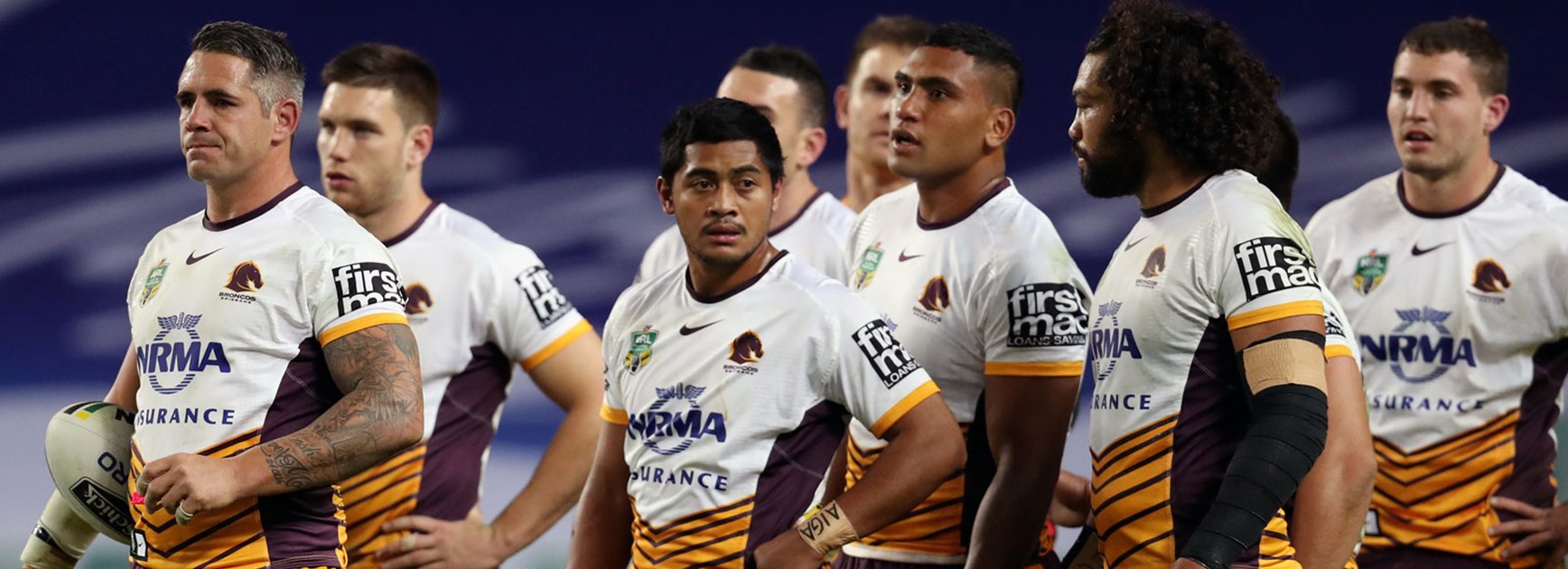 Broncos players look on during their loss to the Roosters.