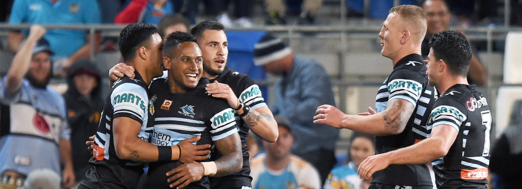 The Sharks celebrate a first-half try against the Titans in Round 21.