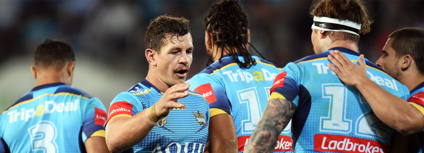 Greg Bird and the Titans celebrate Chris McQueen's try against Cronulla on Monday night.
