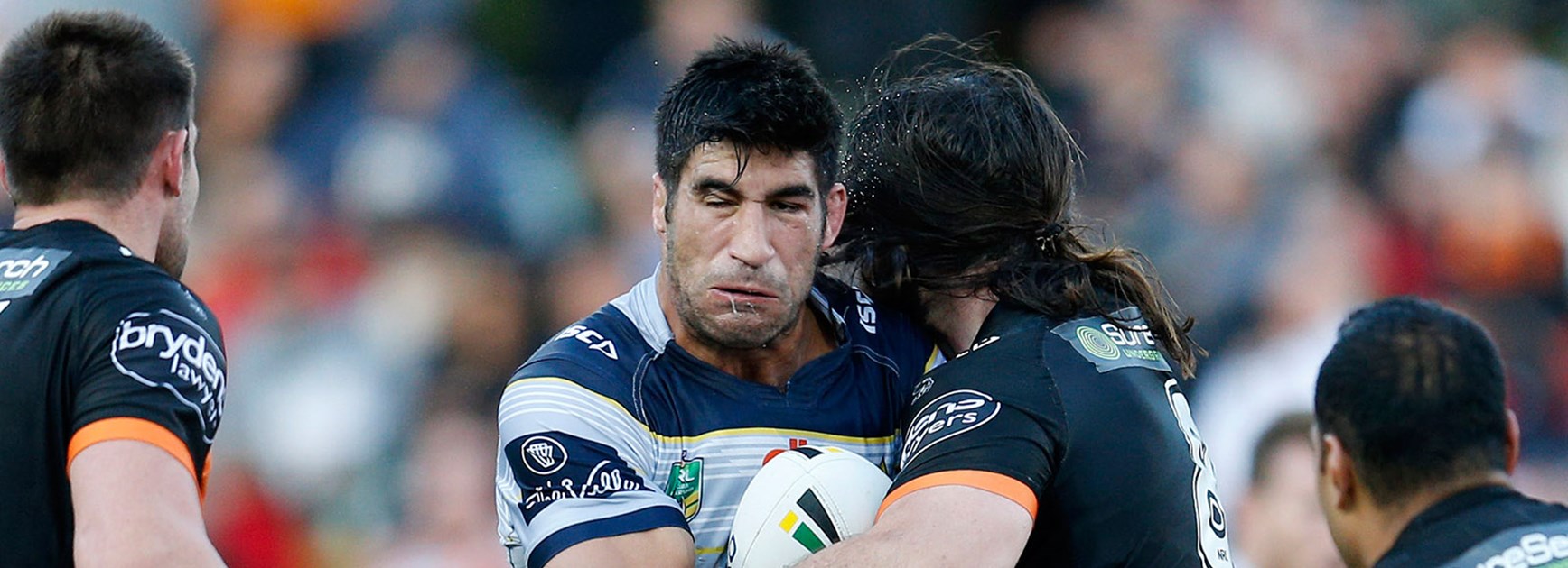 James Tamou is tackled by Aaron Woods.