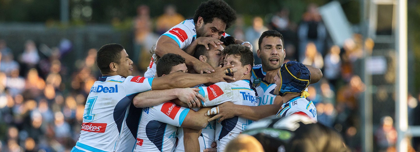Titans players celebrate their one point win over Wests Tigers.