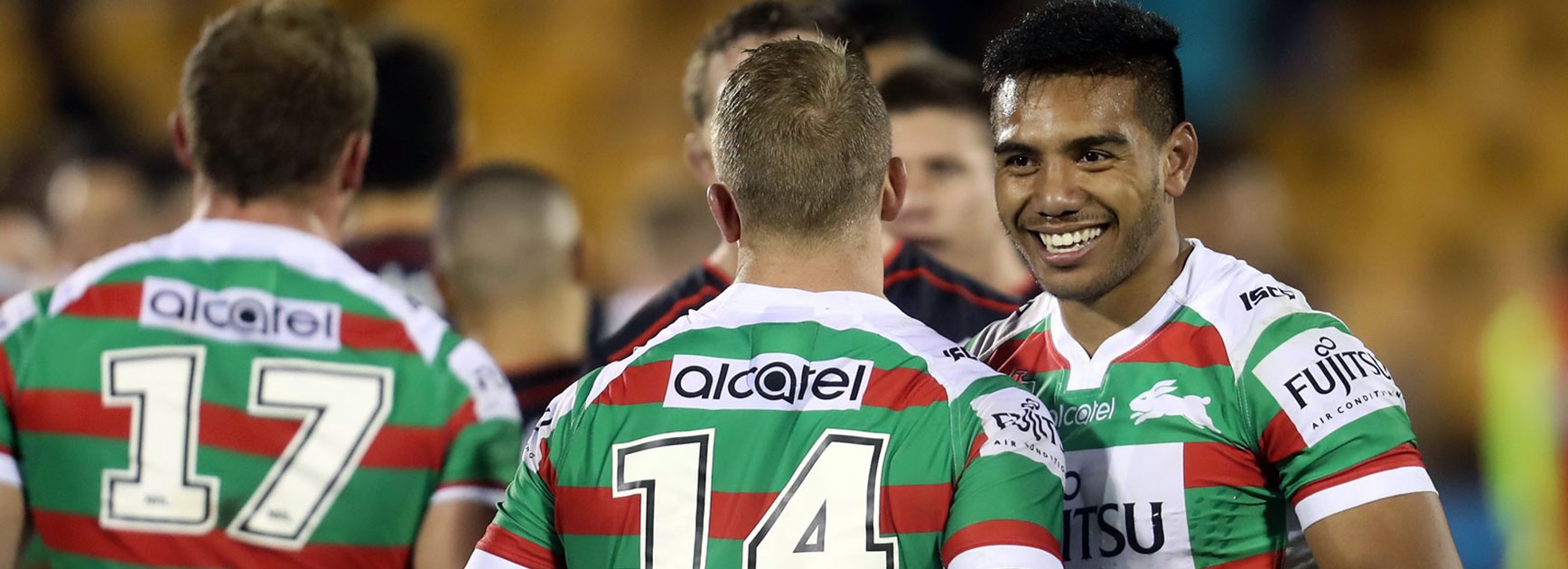 Rabbitohs players celebrate victory over the Warriors.