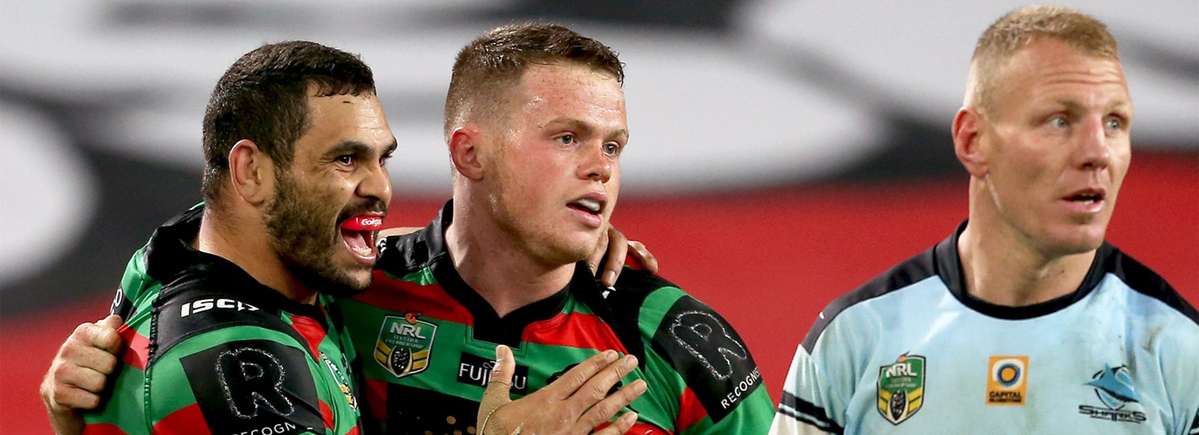 Greg Inglis and Joe Burgess celebrate Burgess's try against the Sharks on Monday night.
