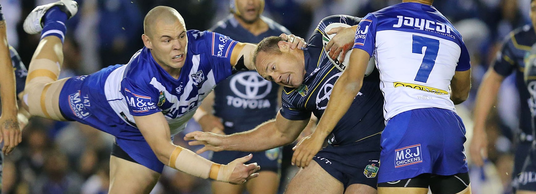 David Klemmer launches himself at Matt Scott during the Bulldogs clash with the Cowboys at Belmore Sports Ground.