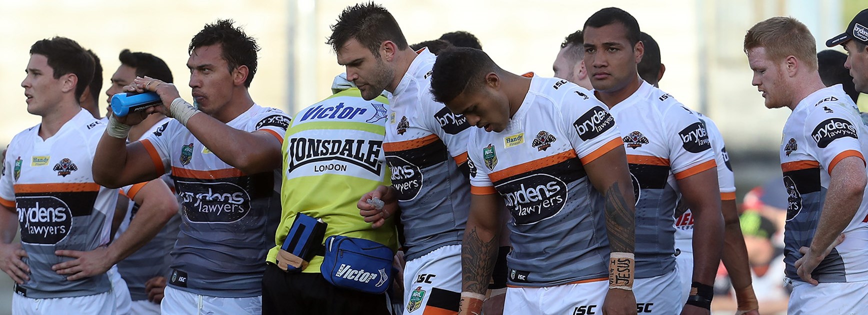 Wests Tigers players look on after a try to the Warriors.