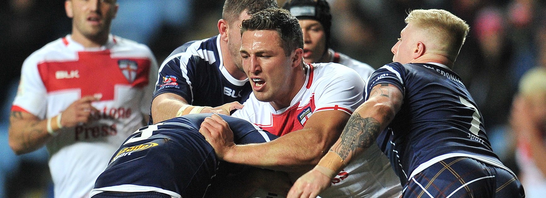 Sam Burgess charges into the Scottish defensive line.