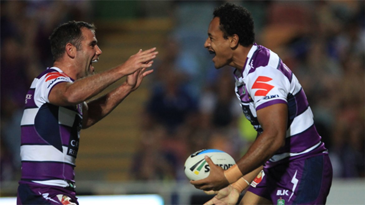 Storm skipper Cameron Smith celebrates Felise Kaufusi's maiden NRL try in the side's win over the Cowboys.