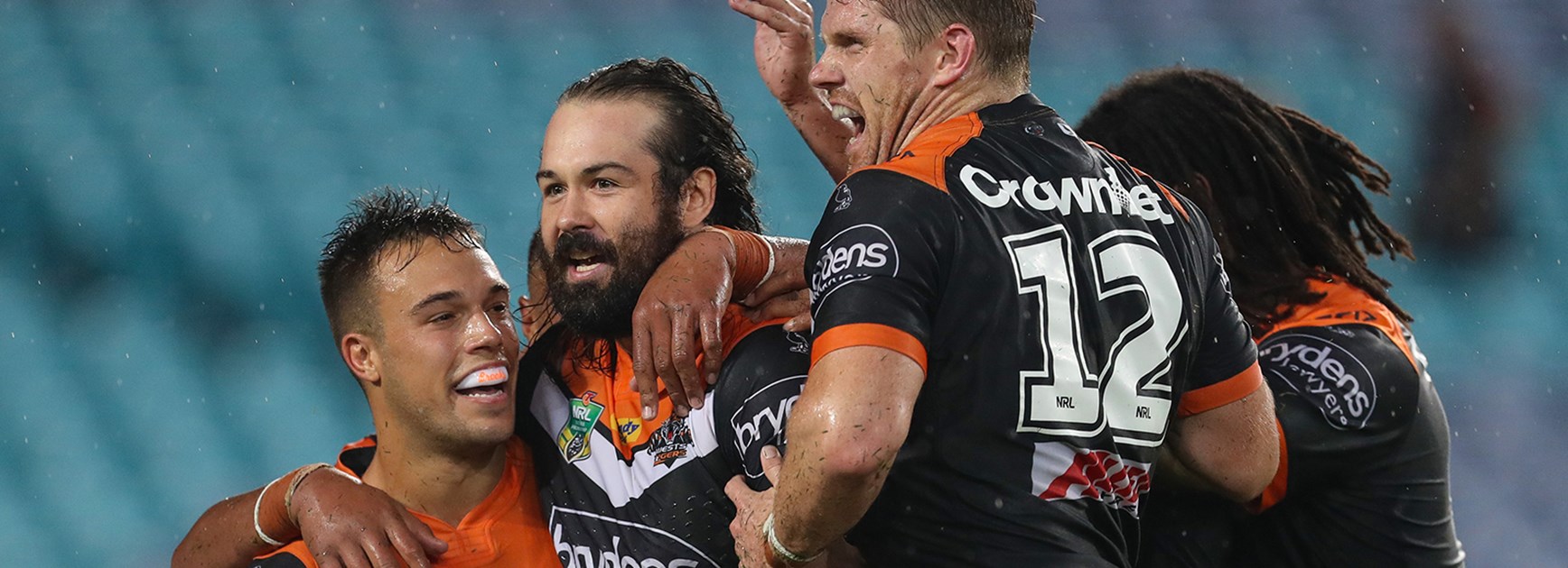 Wests Tigers captain Aaron Woods celebrates one of his side's tries against the Rabbitohs in Round 1.