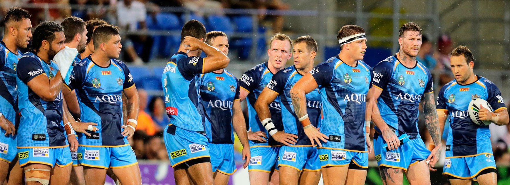 Titans players look on in their loss to the Roosters.